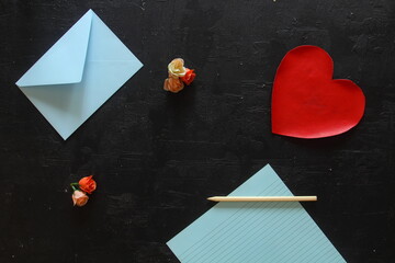 Blank page of notepad, pen and red paper heart. Valentine's day card, wedding checklist, love letter or writing in dairy concept. Flat lay, top view mock up with copy space