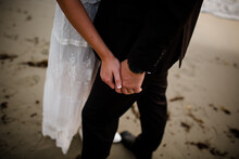 Close Up Of Newlyweds Hands On Beach In San Diego