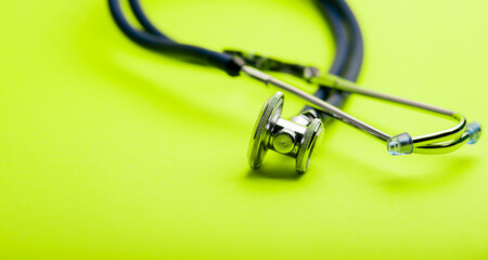 Selective focus of blue stethoscope on green background. For check heart or health check up concept. Copy space..