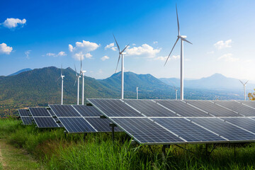 photovoltaic modules solar power plant with wind turbines against mountains landscape against blue s