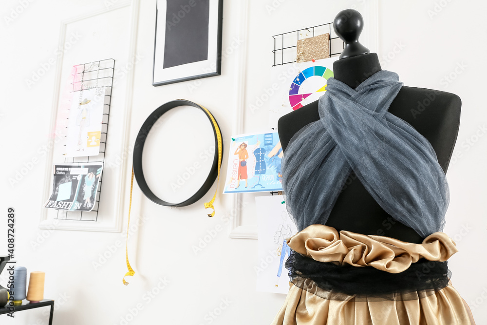 Mannequin with stylish clothes in atelier