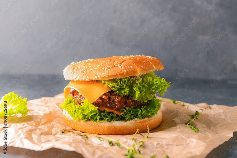 Tasty burger on dark background