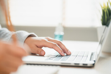 Canvas Print - women using laptop computer with write note at home, work from home concept