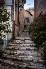  street scene with stairs leading into village ,Fontaine de Vaucluse , Provence ,france .