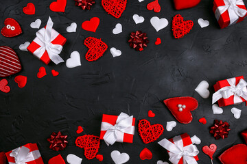 Wall Mural - Frame of gifts, hearts and bows on black background. Valentine's day concept.