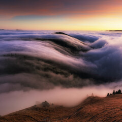 Wall Mural - mountain landscape above clouds at sunset in slovakia with forest and sun