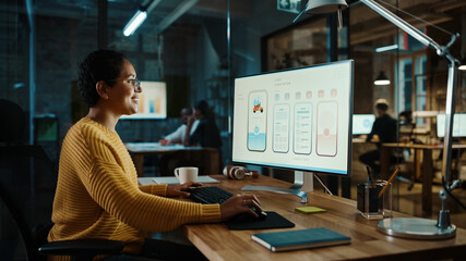 Young Latina Designer Working on a Desktop Computer in Creative Office. Beautiful Diverse Multiethnic Female is Developing a New App Design and User Interface in a Digital Graphics Editing Software.