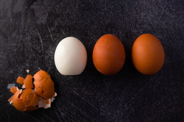 Wall Mural - three boiled eggs, one peeled