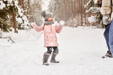 Little Girl During A Snowball Fight In The Snow