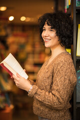 Wall Mural - woman in library reading book. 