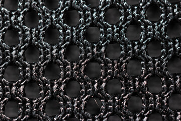 Black fabric chair backrest mesh net weave extreme macro front view