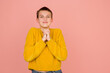 Hopeful asking. Caucasian girl's portrait on coral pink studio background with copyspace for ad. Beautiful model in sweater. Concept of human emotions, facial expression, sales, ad, fashion.