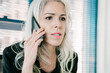 © Mangostar - Confident businesswoman talking via phone in office room and looking at something. Closeup portrait of CEO discussing project on smartphone. Business, communication and top management concept