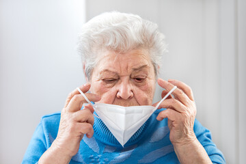 portrait of a senior adult woman, wearing a ffp2 mask