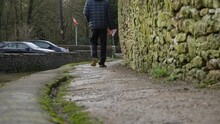 Low Angle Shot Of Person Walking Along Rural Village Path