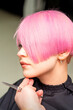© okskukuruza - Male hairdresser makes short pink hairstyle for a young caucasian woman in a beauty salon