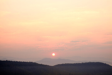 The sun rises in the morning on the mountain of the new day.