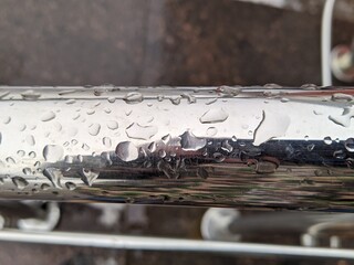water droplets on the metal rail closeup photo