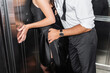 © LIGHTFIELD STUDIOS - partial view of man touching woman in elegant black dress in elevator