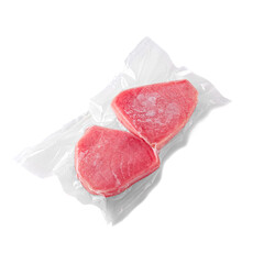 Frozen tuna steak. In plastic packaging. White background. Isolated.