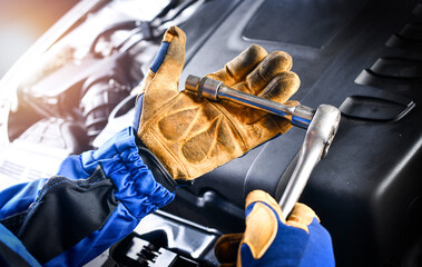 Wall Mural - Auto mechanic working on car broken engine in mechanics service or garage.