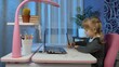 © Andrii Iemelianenko - Child schoolgirl learning lessons being at home sitting at table using laptop digital computer. Portrait of kid girl distance education. Studying during coronavirus lockdown. Slow motion. 6k downscale