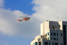 Red Private Helicopter On Blue Sky  , Secure Helicopter Flying Practice The Emergency Case Over The Building