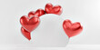 Balloons in the form of romantic red hearts behind a round stand on an isolated white background..