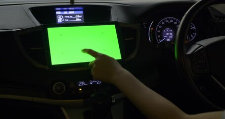 Driver use a multimedia center with green screen
