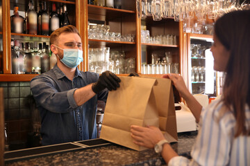 Sticker - Waiter giving packed takeout order to customer in restaurant. Food service during coronavirus quarantine