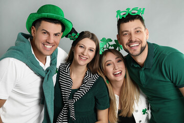 Wall Mural - Happy people in St Patrick's Day outfits on light grey background