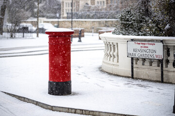 Wall Mural - London classic red mailbox  under the falling snow