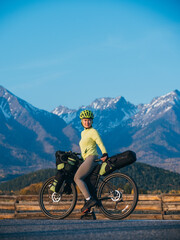 the woman travel on mixed terrain cycle touring with bikepacking. the traveler journey with bicycle 
