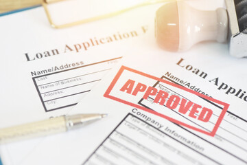 Loan application form with Rubber stamping that says Loan Approved, Financial loan money contract agreement company credit or person loan approval