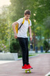 © Natali - Teenager in white t-shirt spends free time training skating in the city park. Practicing skills freestyle, making tricks. A cute nice boy enjoys a sunny day outdoors with a skateboard. Hobby, sport
