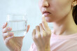 © lili - the girl drinks a pill and drinks water