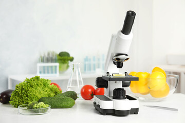 Wall Mural - microscope and fresh vegetables on table in laboratory. poison detection