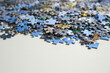 © New Africa - Puzzle pieces on white table, closeup view