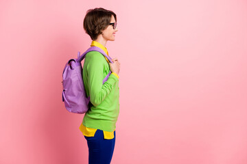 Poster - Photo of confident smart young woman wear green cardigan spectacles rucksack looking empty space isolated pink color background