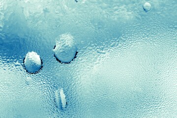 Drops of water on frosty surface closeup