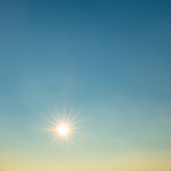 sun shining at a clear blue sky