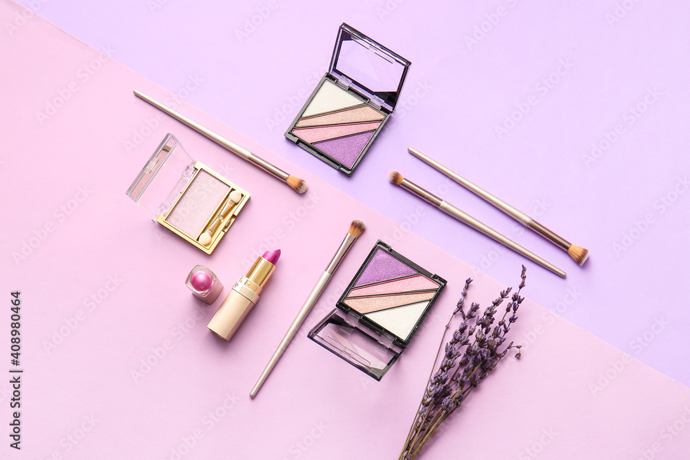 Beautiful eyeshadows, lipstick and brushes on color background