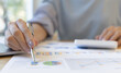 © Kantamard - Accounting businesswomen are calculating income-expenditure and analyzing real estate investment data, Dedicated to the progress and growth of the company, Financial and tax systems concept.
