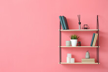 Modern Shelf With Books And Decor On Color Wall