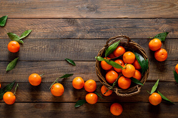 Sticker - Tangerines, fresh mandarin oranges, clementines with leaves on wooden background. Top view, copy space