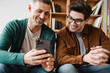 © Drobot Dean - Happy young gay couple using mobile phone