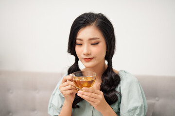 Wall Mural - young attractive asian woman who drink tea