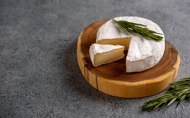 Brie cheese. Camembert cheese. Brie cheese or Camembert cheese  on a wooden board.