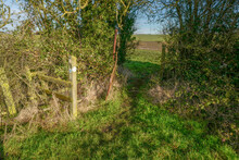 A Stile In A Hedgerow In The Countryside Over Public Footpath 