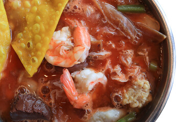 Top view of Sea foods Yentafo soup in the hot pot. Thai Foods concept.